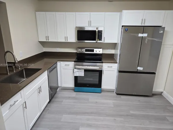 a kitchen with a sink a stove and refrigerator
