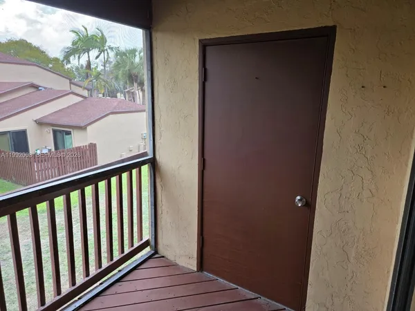 a view of a balcony with wooden floor