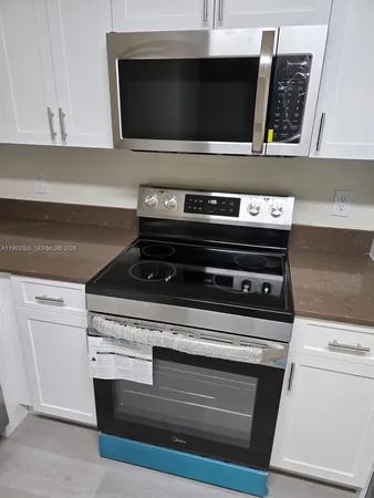 a stove top oven sitting inside of a kitchen