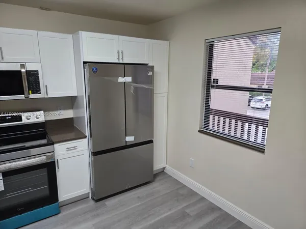 a kitchen with stainless steel appliances a refrigerator and a stove top oven