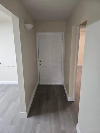 an empty room with wooden floor