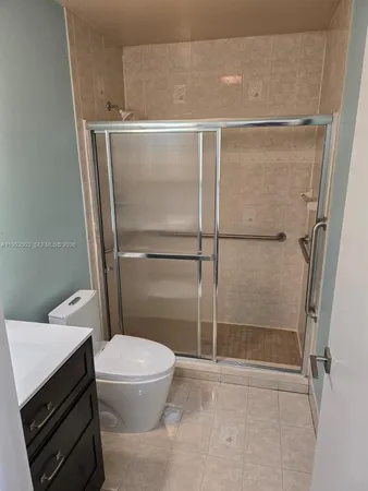 a bathroom with a shower and a toilet