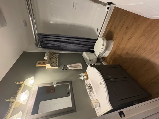 a living room with stainless steel appliances granite countertop lots of white furniture