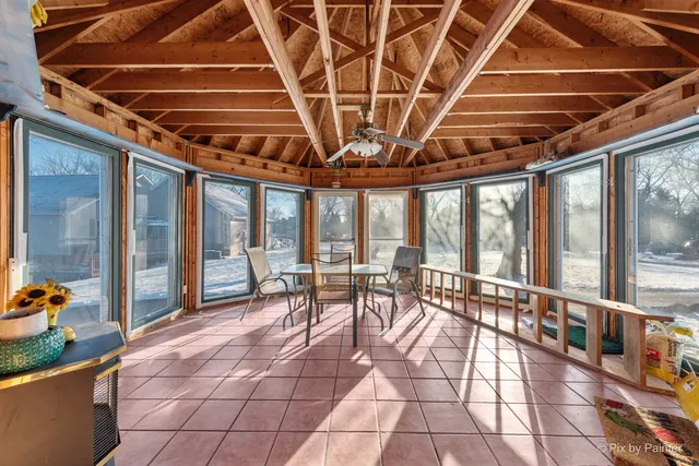 a view of a storage area with a table and chairs