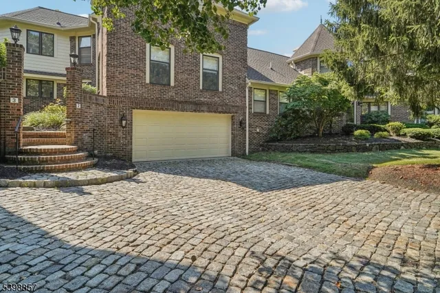 a front view of a house with a yard and a garage