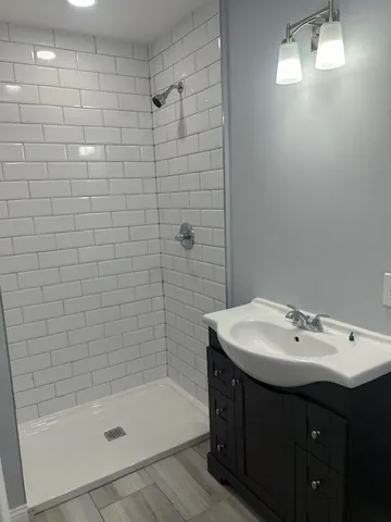 a bathroom with a sink shower and a bathtub