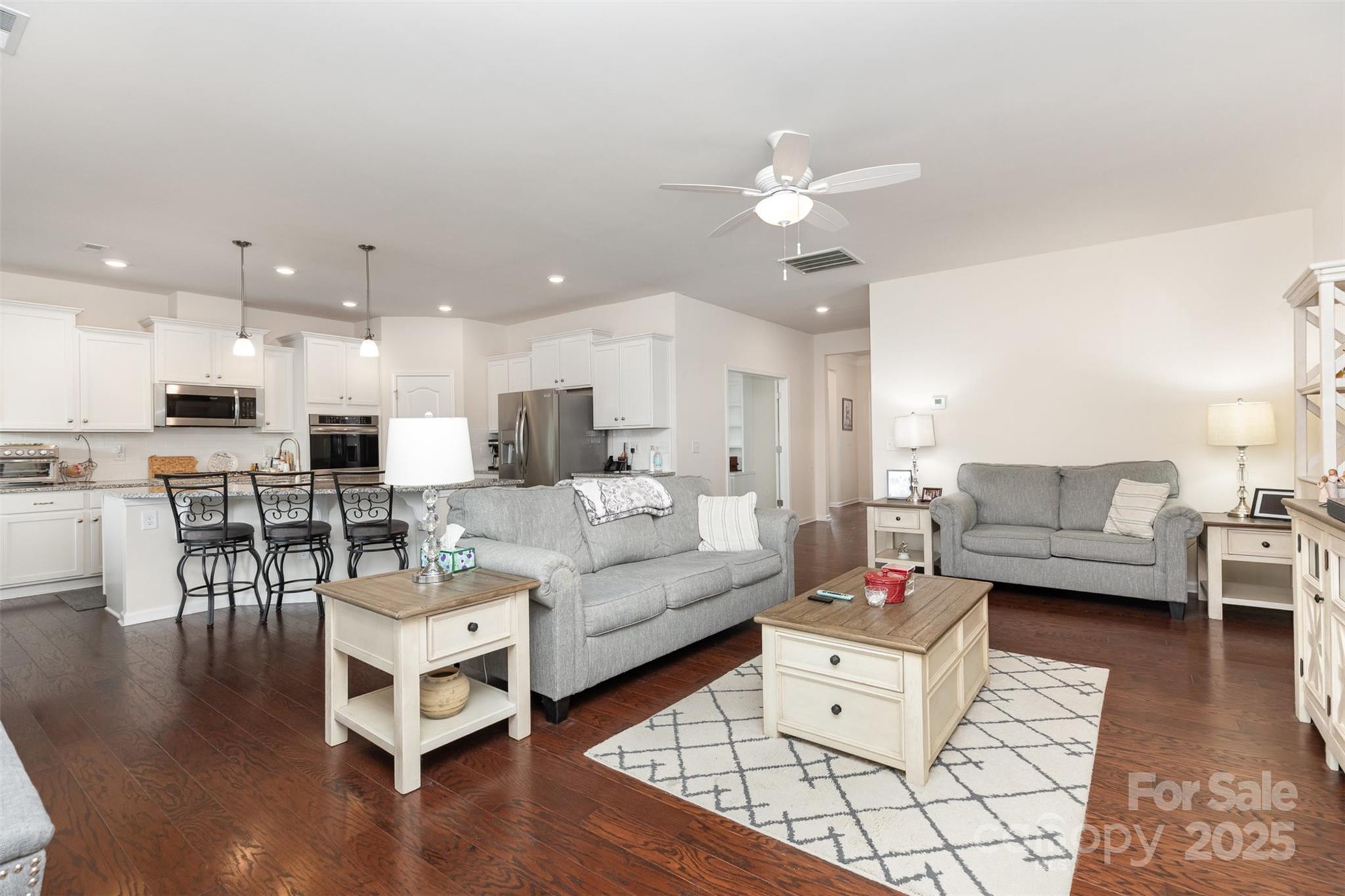 1663 Tranquility Boulevard Lancaster, SC 29720 - Photo 11 of 42 a living room with furniture and kitchen view with wooden floor