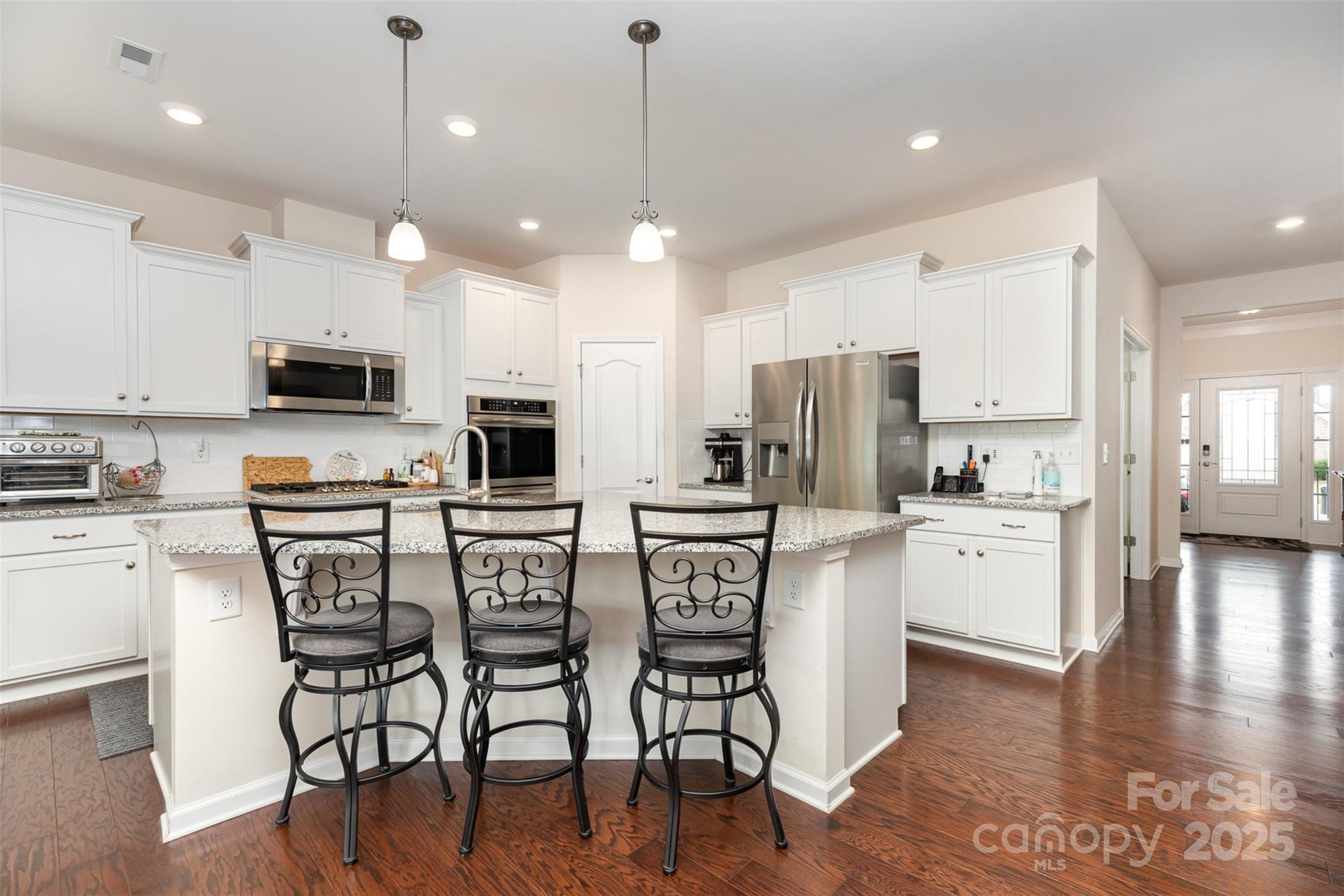 1663 Tranquility Boulevard Lancaster, SC 29720 - Photo 15 of 42 a kitchen with microwave a refrigerator and chairs