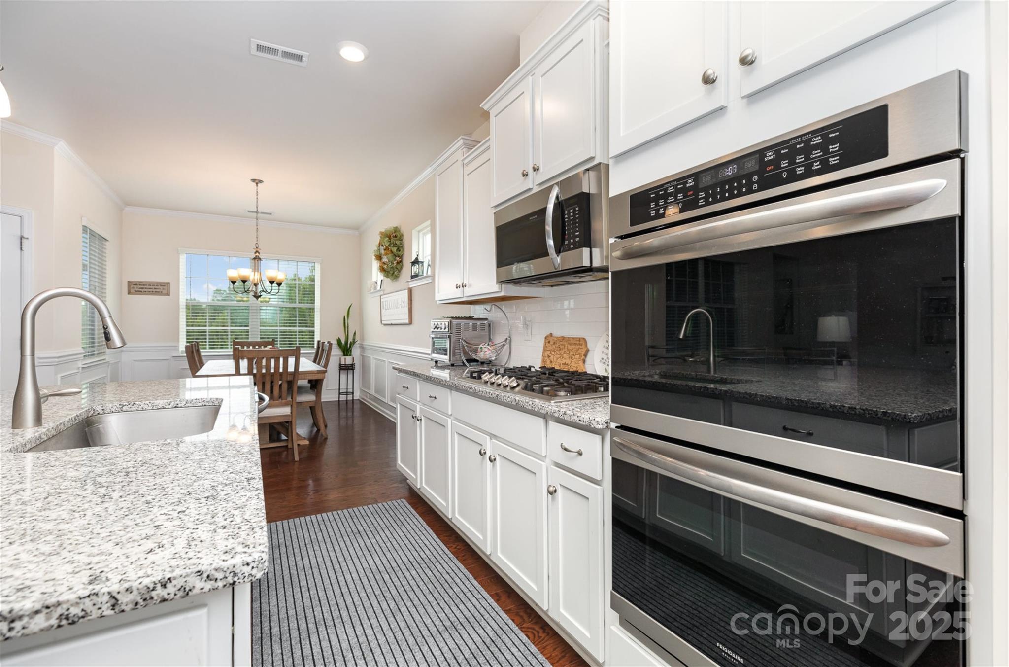 1663 Tranquility Boulevard Lancaster, SC 29720 - Photo 17 of 42 a kitchen with stainless steel appliances sink stove microwave and cabinets