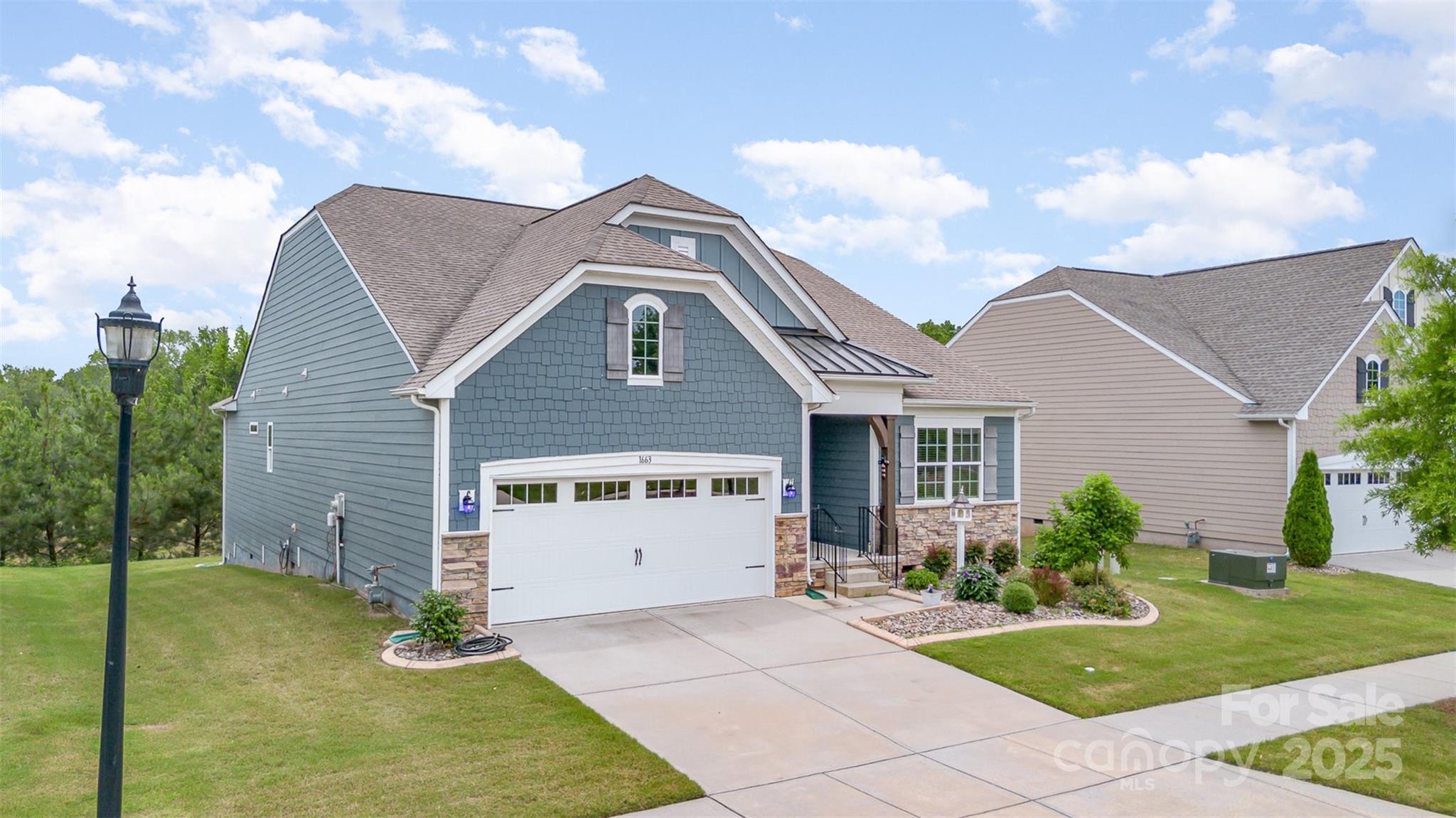 1663 Tranquility Boulevard Lancaster, SC 29720 - Photo 3 of 42 a front view of a house with garden