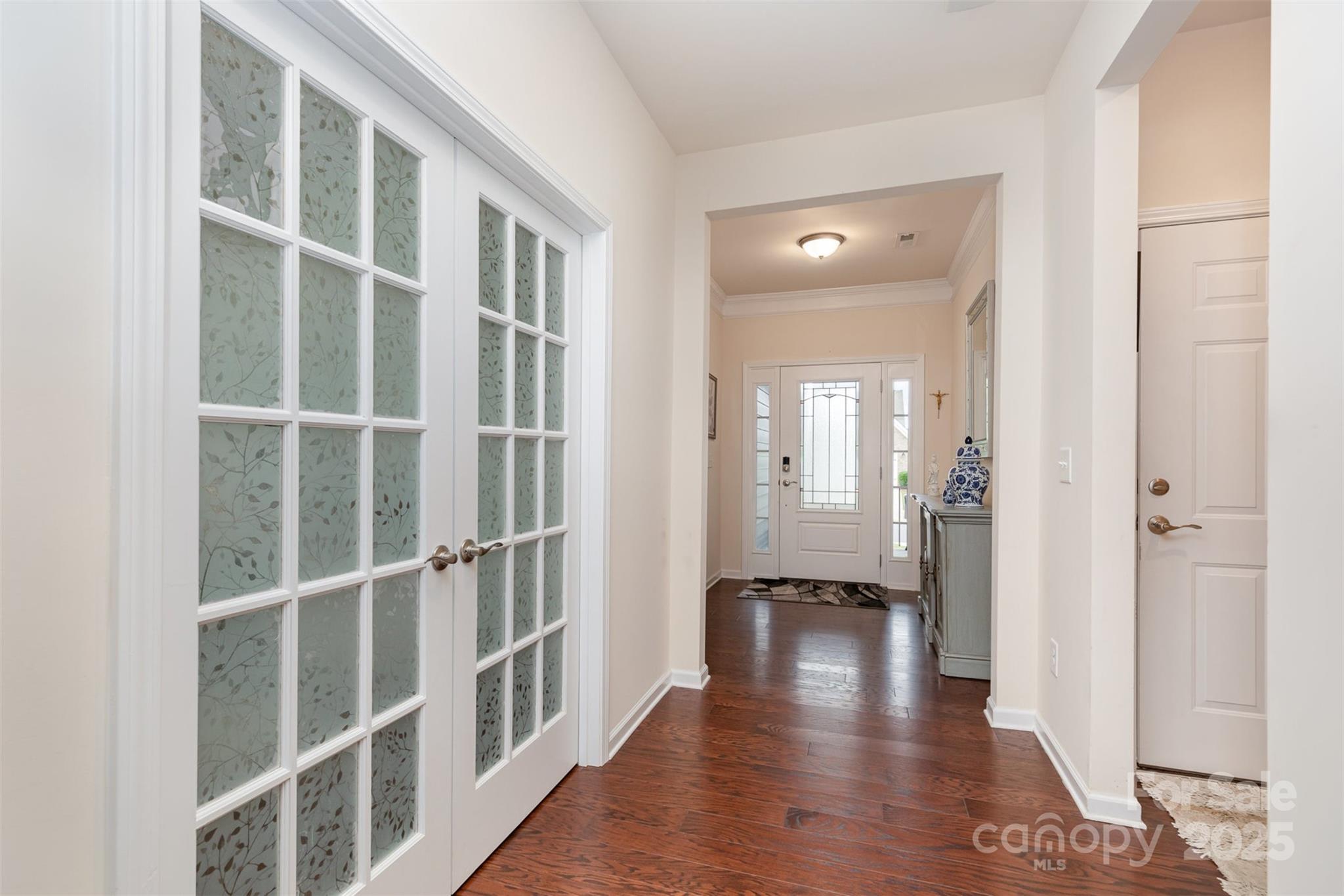 1663 Tranquility Boulevard Lancaster, SC 29720 - Photo 6 of 42 a view of a hallway with wooden floor and windows