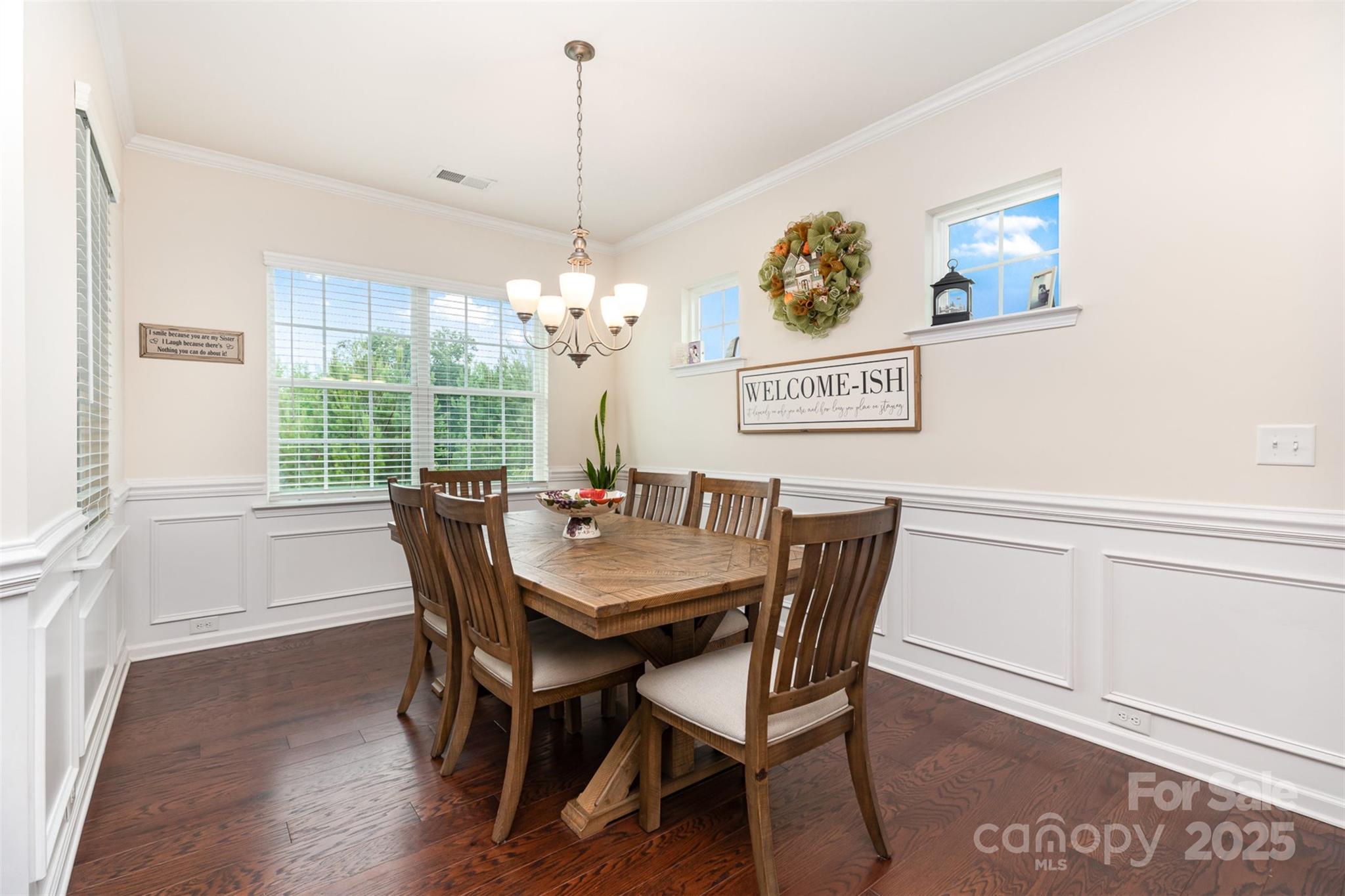 1663 Tranquility Boulevard Lancaster, SC 29720 - Photo 9 of 42 a view of a dining room with furniture wooden floor and a chandelier