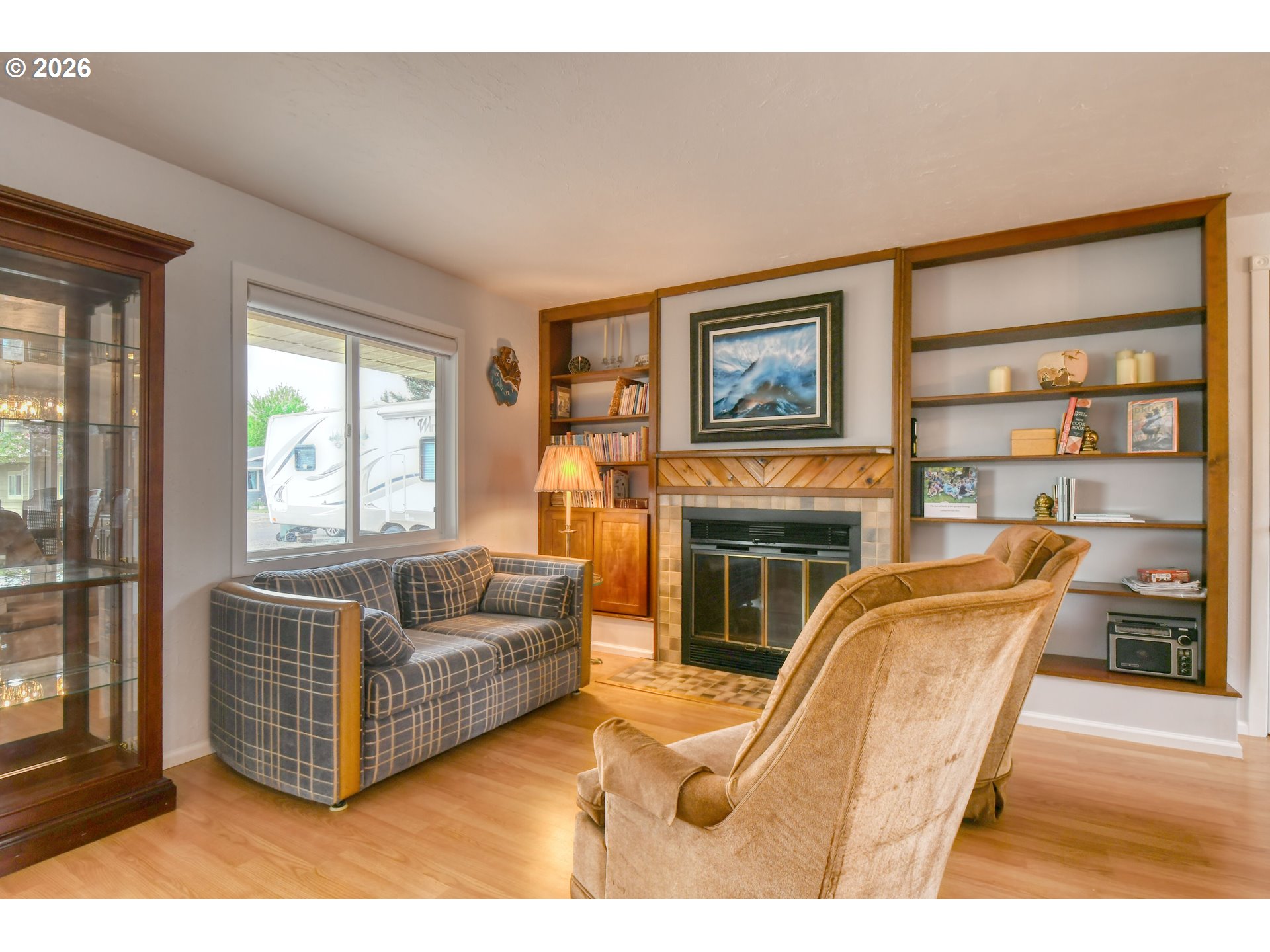 329 West Garfield Street Athena, OR 97813 - Photo 22 of 46 a living room with furniture a fireplace and a large window