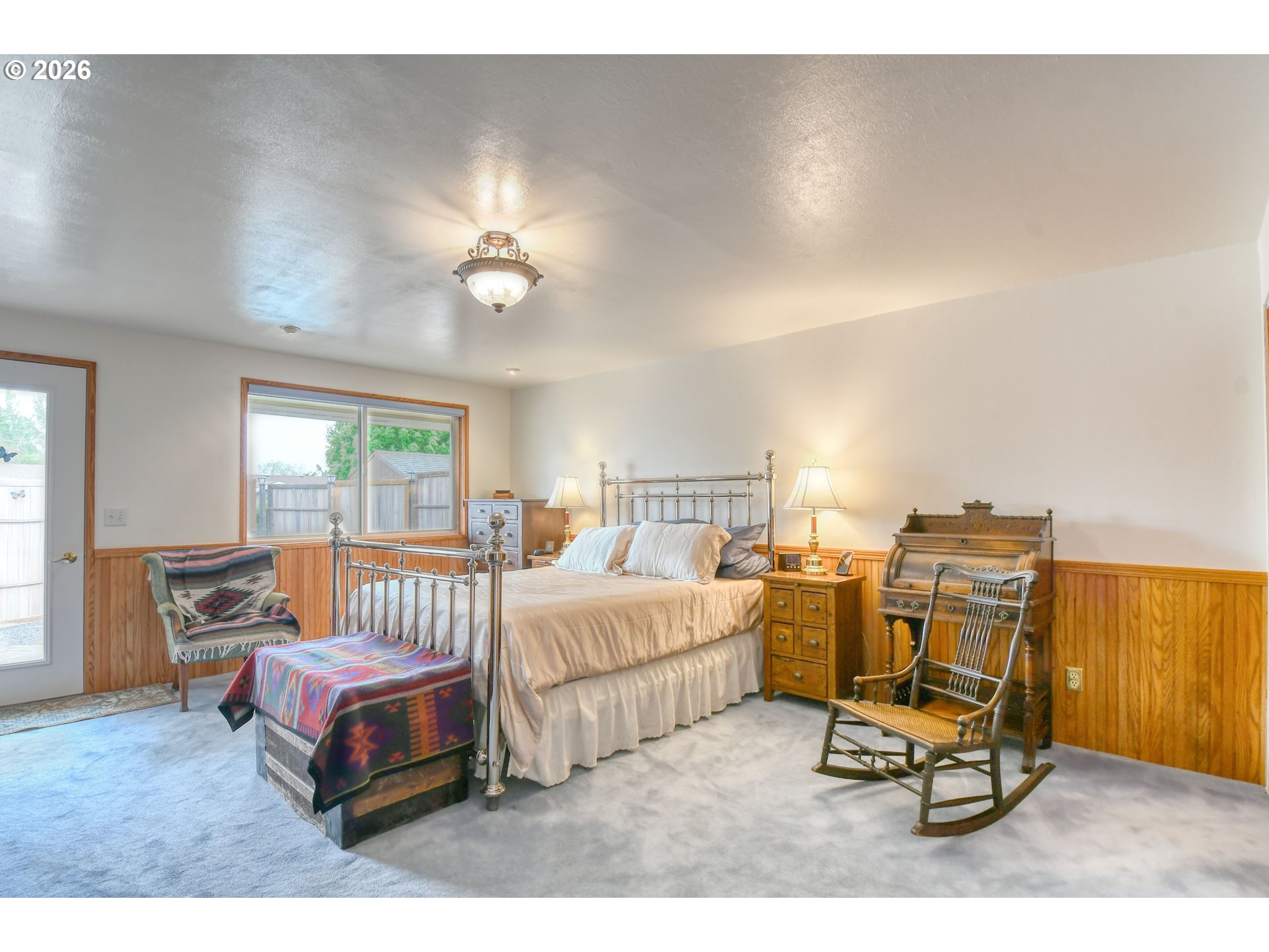 329 West Garfield Street Athena, OR 97813 - Photo 23 of 46 a bedroom with a bed and a chandelier