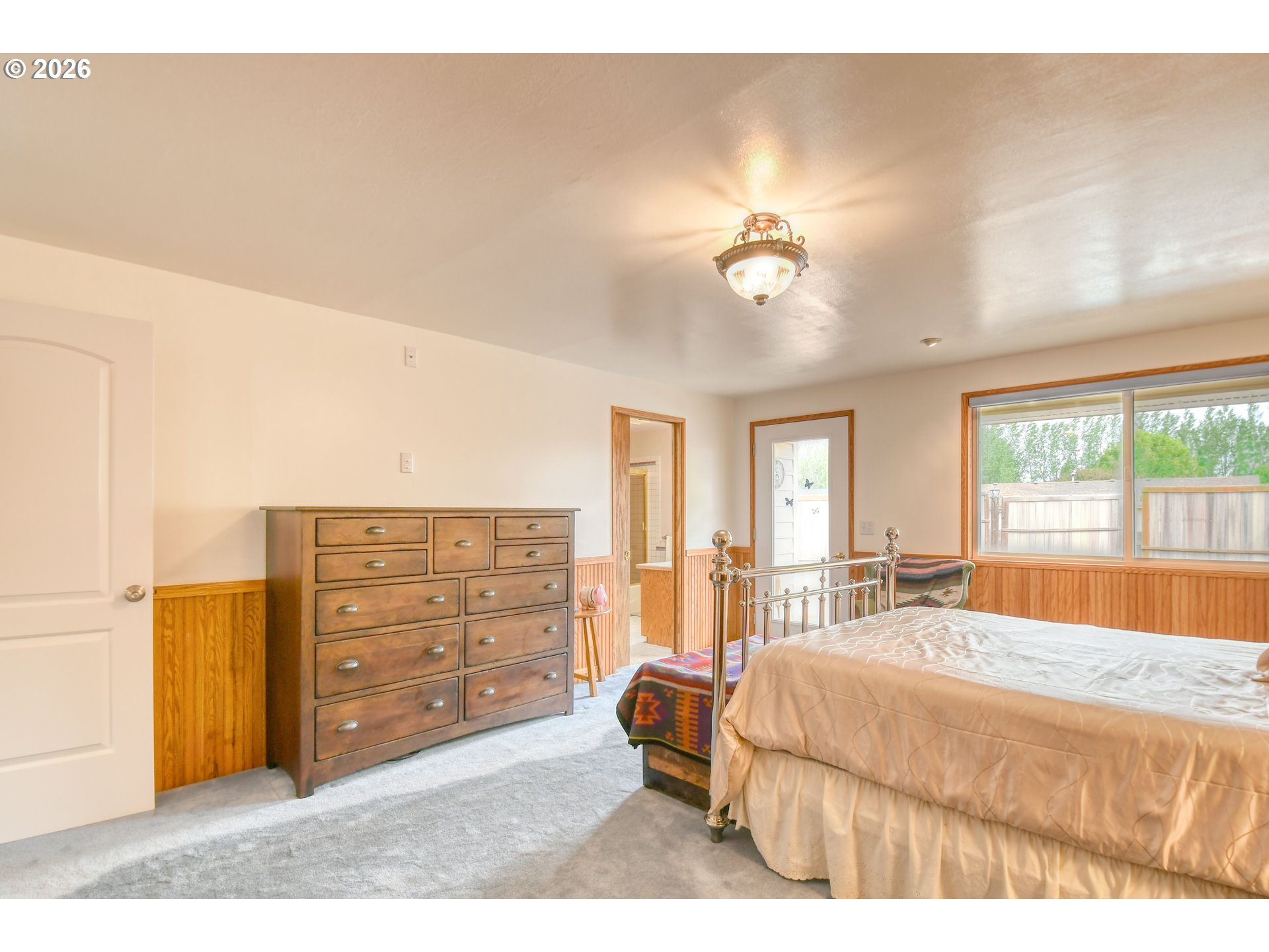 329 West Garfield Street Athena, OR 97813 - Photo 25 of 46 a spacious bedroom with a bed and a chandelier