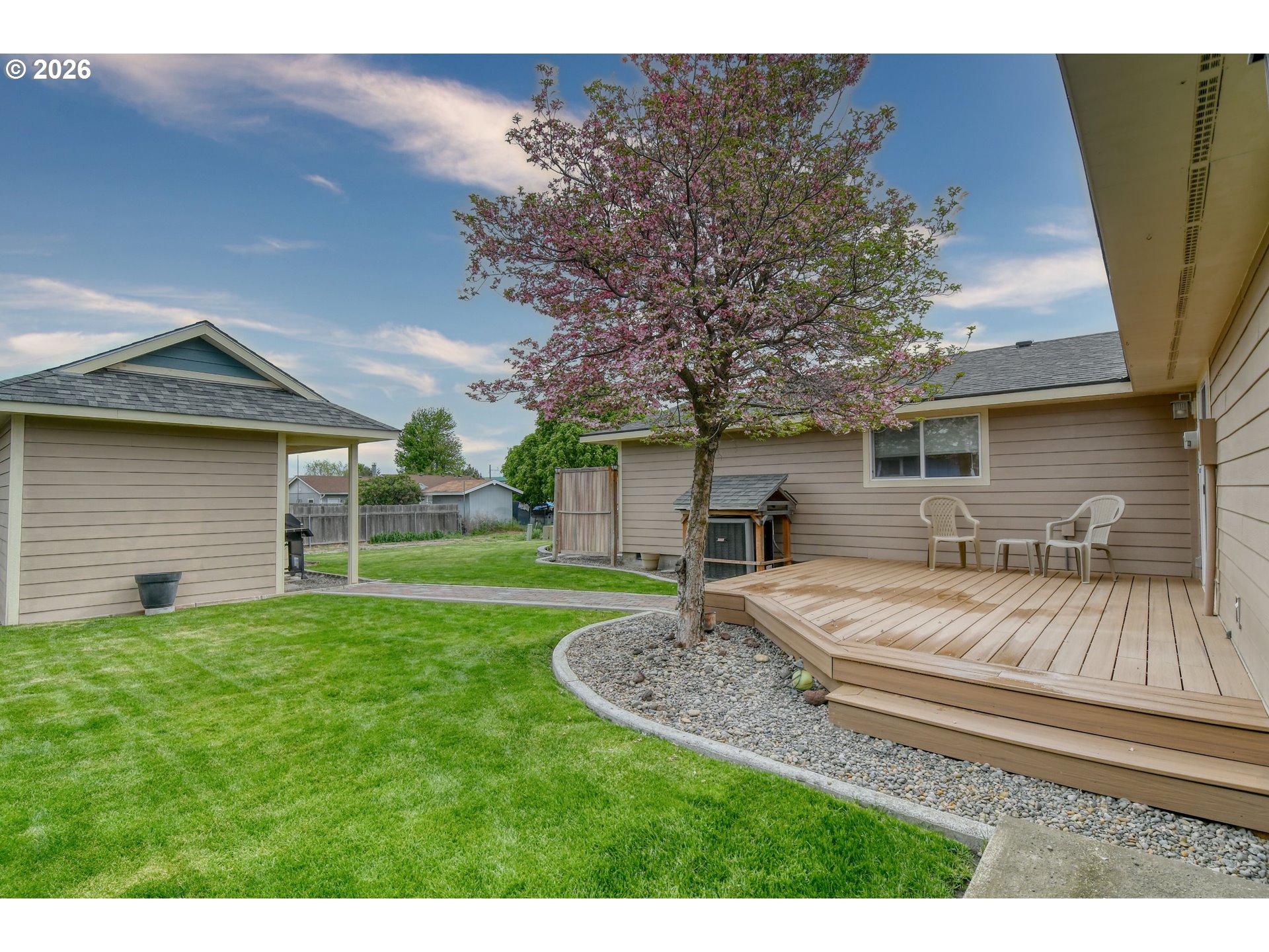 329 West Garfield Street Athena, OR 97813 - Photo 40 of 46 a view of a house with a small yard and a large tree