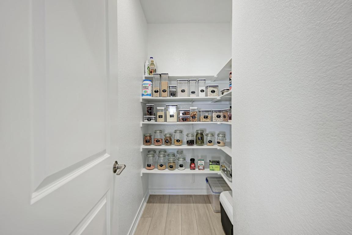 113 Rampart Loop Liberty Hill, TX 78642 - Photo 10 of 40 a view of washer and dryer with kitchen in the background