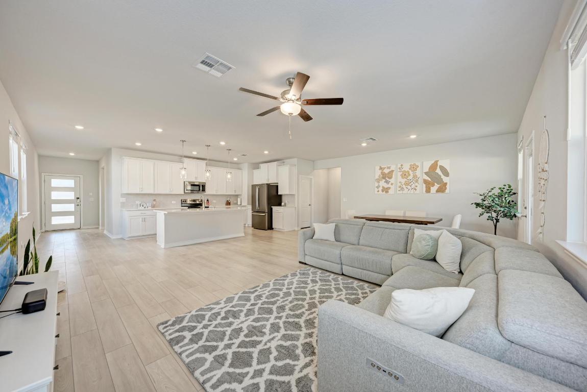 113 Rampart Loop Liberty Hill, TX 78642 - Photo 13 of 40 a living room with furniture and a view of kitchen