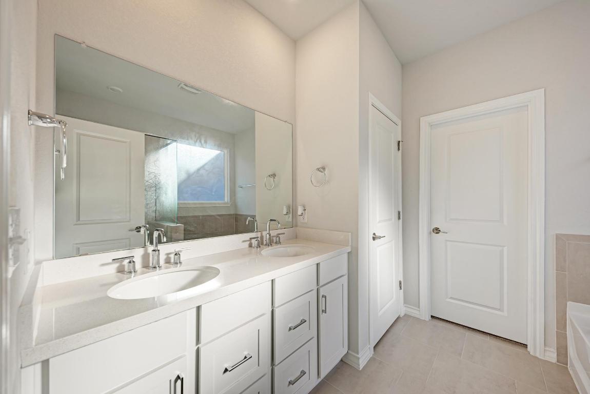 113 Rampart Loop Liberty Hill, TX 78642 - Photo 17 of 40 a bathroom with a sink and a mirror