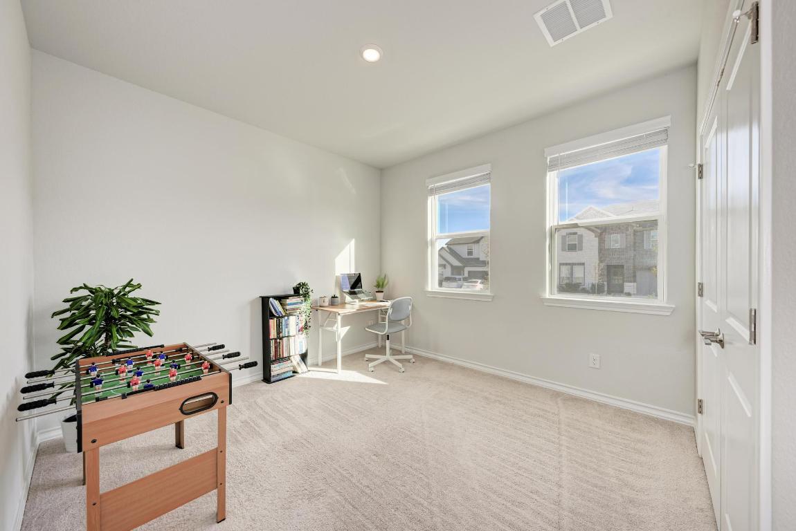 113 Rampart Loop Liberty Hill, TX 78642 - Photo 20 of 40 a living room with furniture and a potted plant