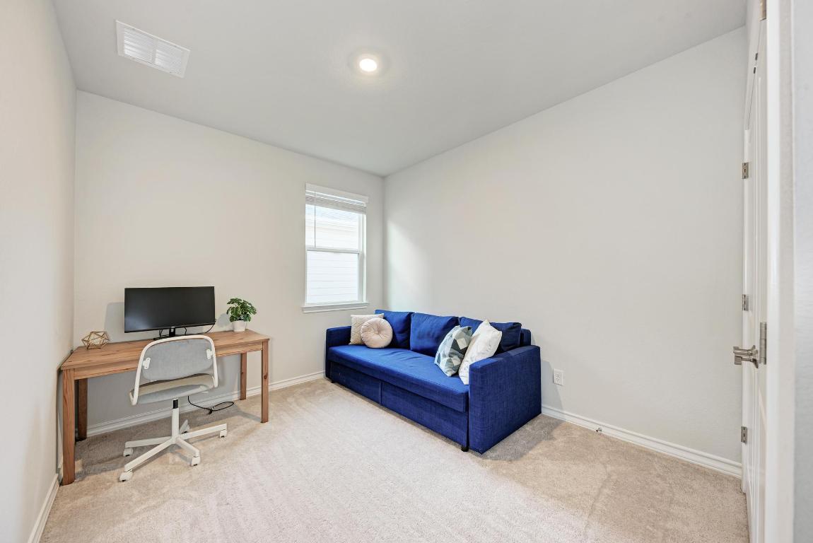 113 Rampart Loop Liberty Hill, TX 78642 - Photo 25 of 40 a living room with furniture and a flat screen tv