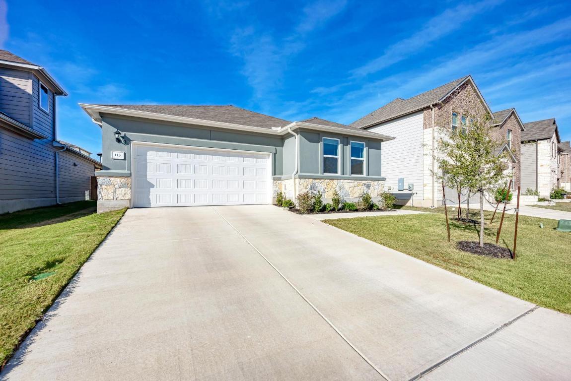 113 Rampart Loop Liberty Hill, TX 78642 - Photo 2 of 40 a front view of a house with a yard
