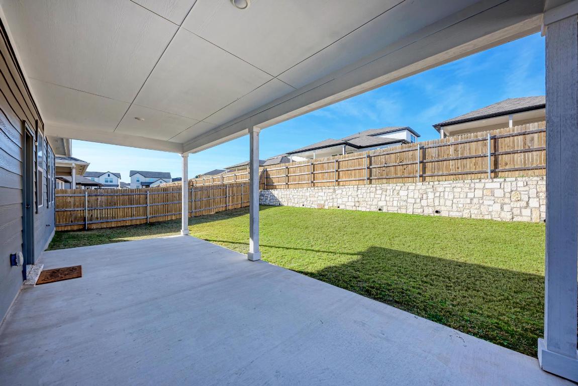 113 Rampart Loop Liberty Hill, TX 78642 - Photo 29 of 40 a view of a backyard with grass
