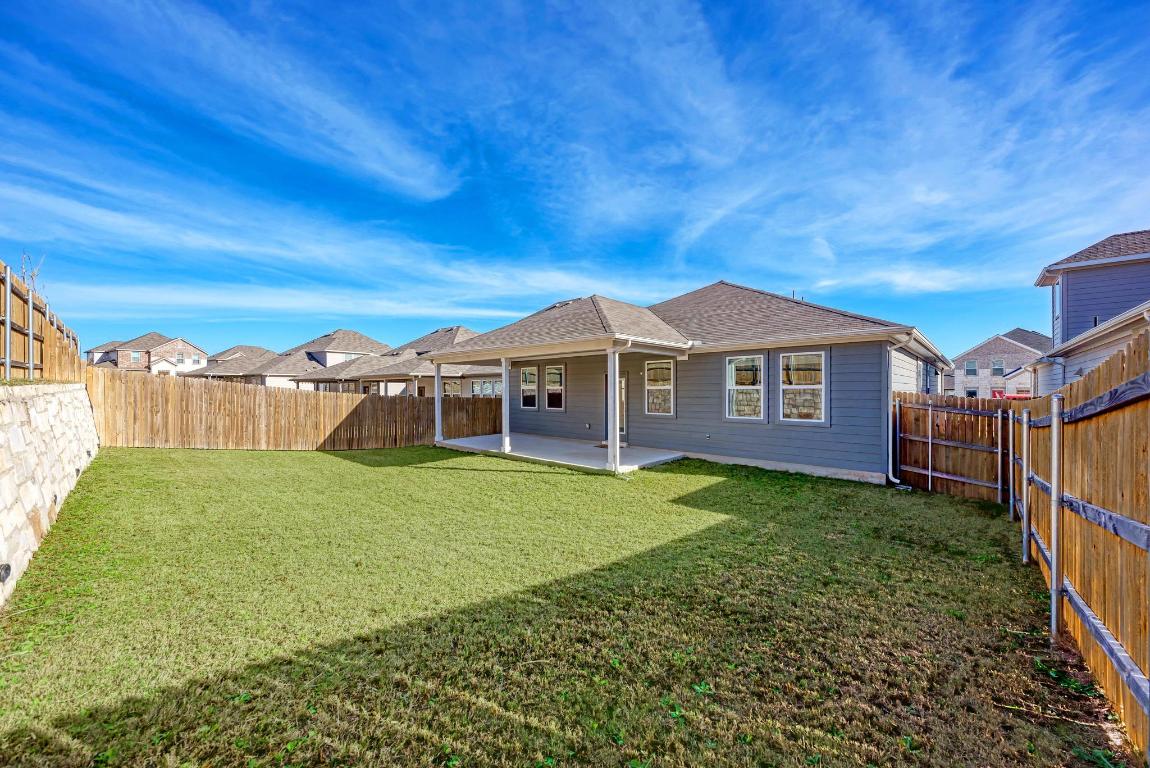 113 Rampart Loop Liberty Hill, TX 78642 - Photo 32 of 40 a view of a yard in front of a house with a yard
