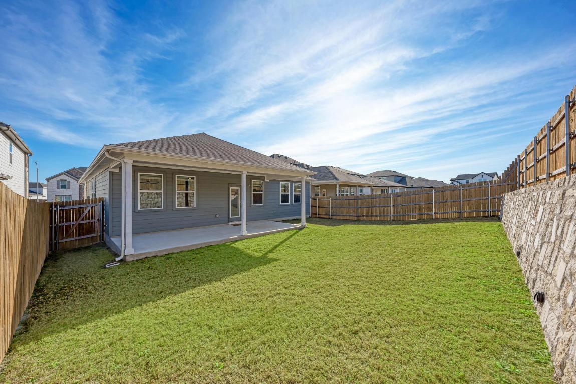 113 Rampart Loop Liberty Hill, TX 78642 - Photo 33 of 40 a view of a house with backyard and garden