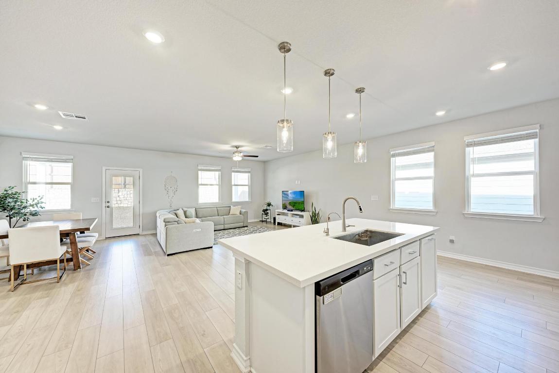 113 Rampart Loop Liberty Hill, TX 78642 - Photo 40 of 40 a kitchen with a sink a counter top space and living room view