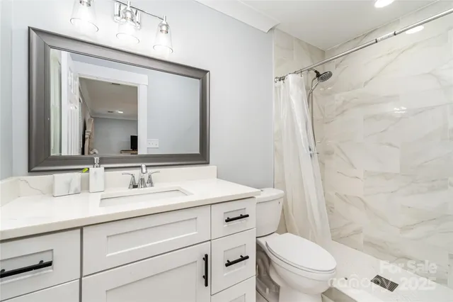 a view of empty room with wooden floor and fireplace