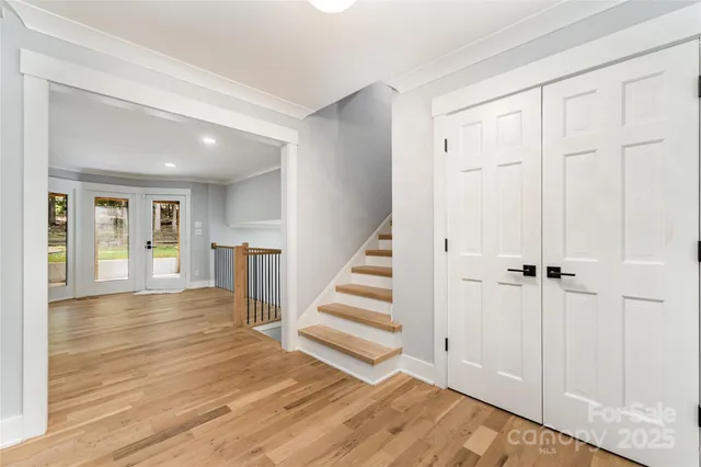 a view of empty room with wooden floor