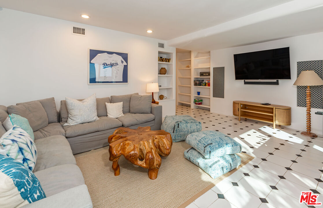 31550 Victoria Point Road Malibu, CA 90265 - Photo 12 of 20 a living room with furniture and a flat screen tv