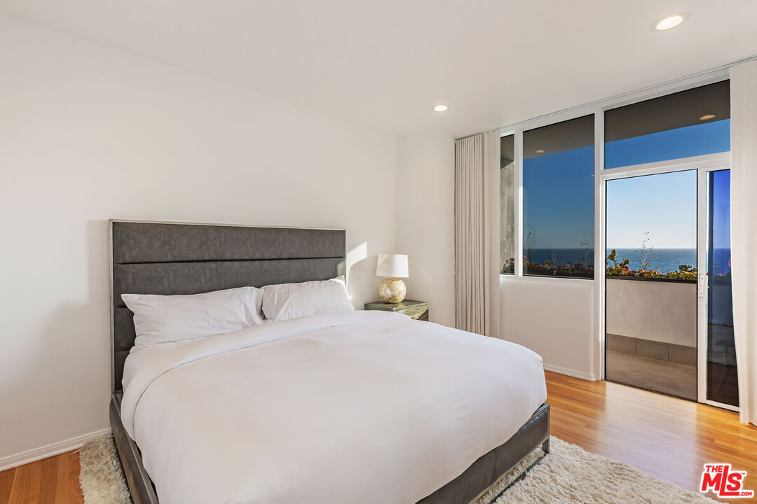 31550 Victoria Point Road Malibu, CA 90265 - Photo 17 of 20 a large bed in a bedroom next to a window