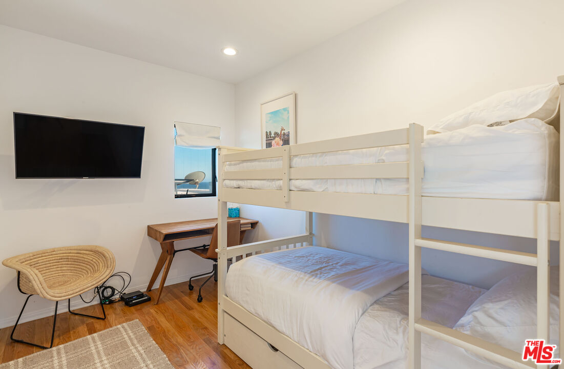 31550 Victoria Point Road Malibu, CA 90265 - Photo 19 of 20 a bedroom with a bed and a chair