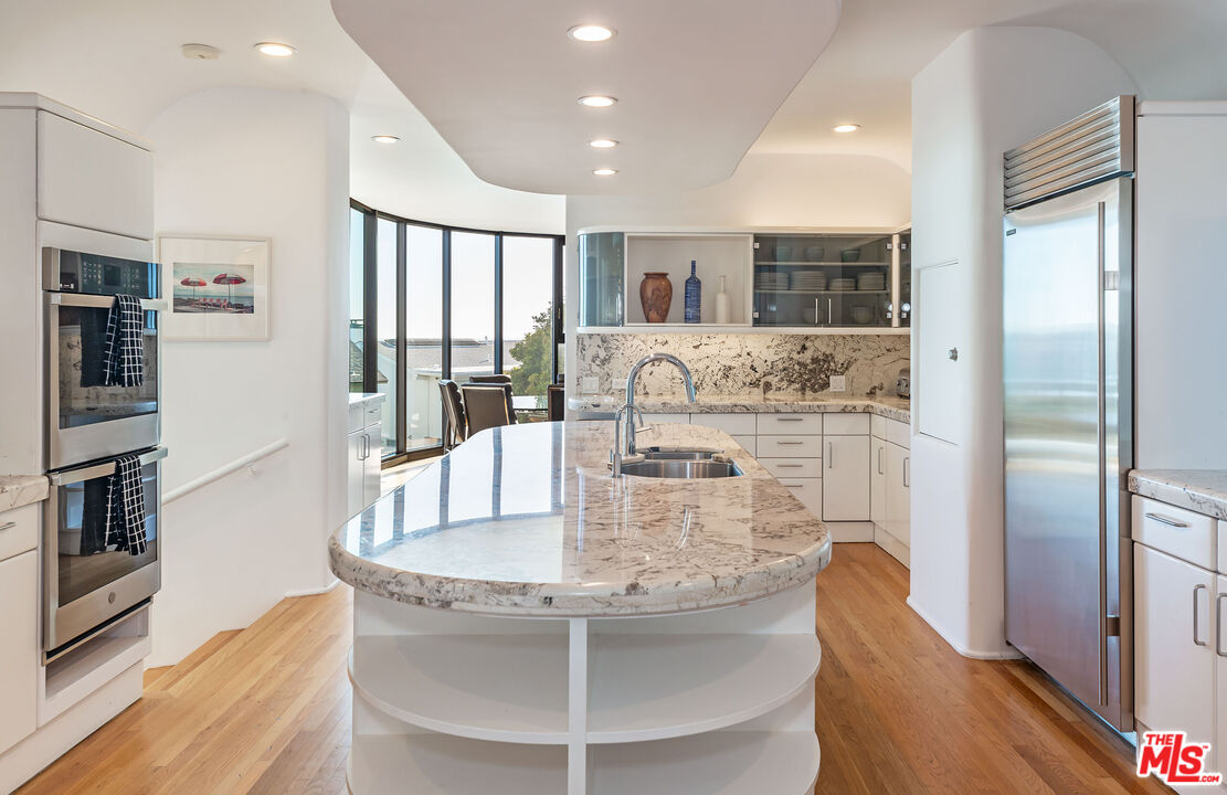 31550 Victoria Point Road Malibu, CA 90265 - Photo 6 of 20 a dining room with stainless steel appliances granite countertop a dining table and chairs