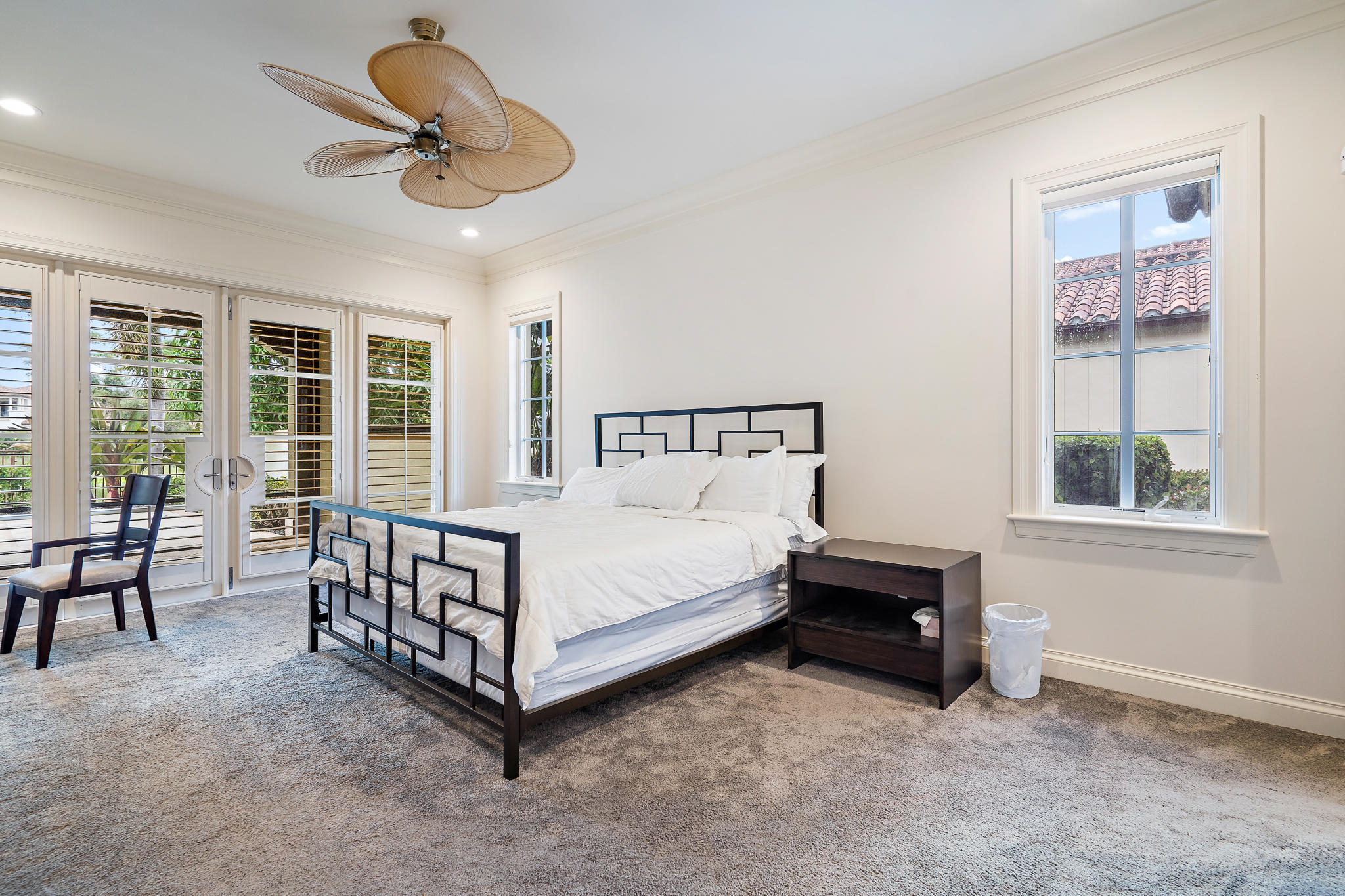 426 Red Hawk Drive Jupiter, FL 33477 - Photo 14 of 40 a white bed sitting in a bedroom next to a window