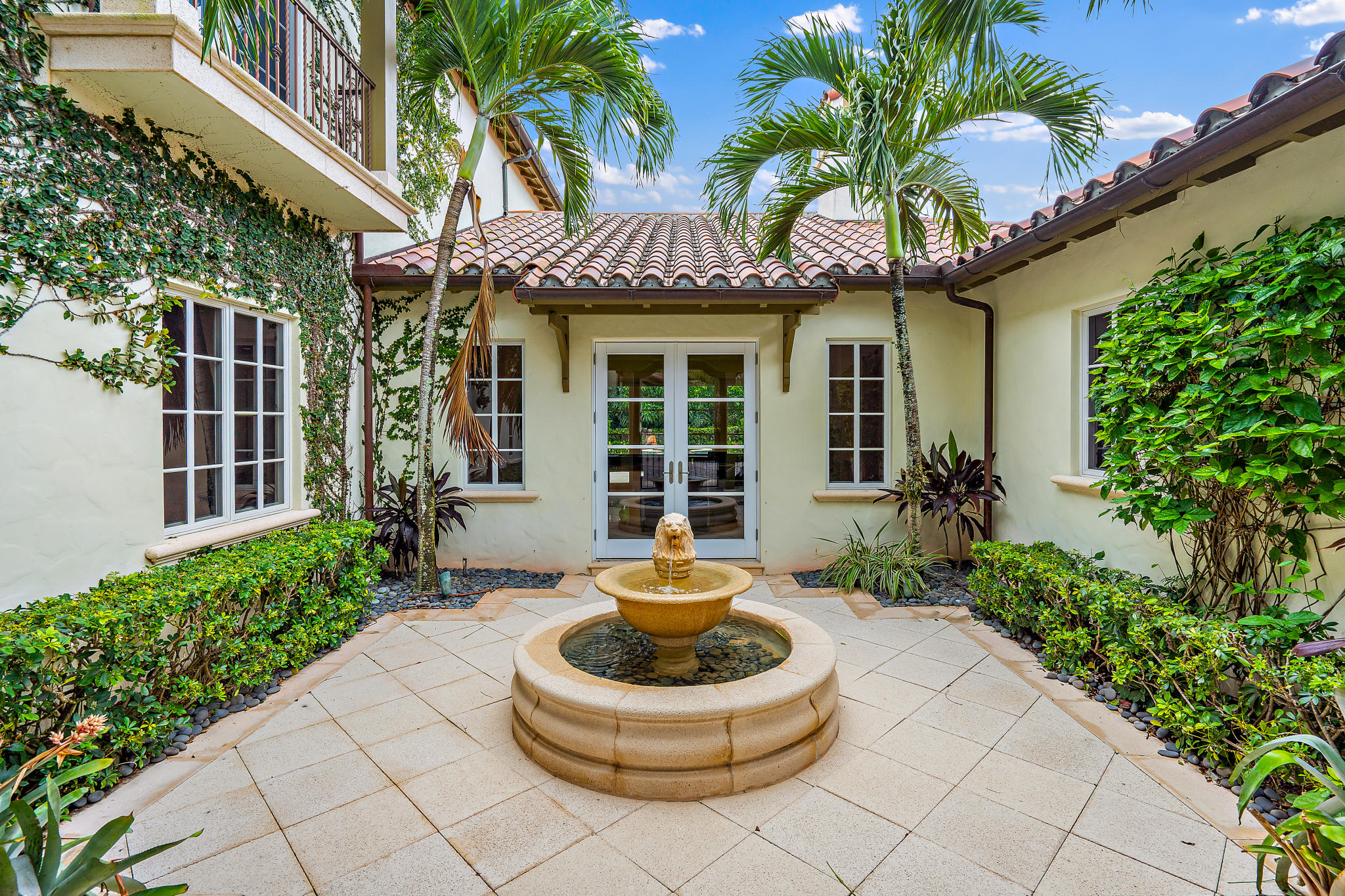426 Red Hawk Drive Jupiter, FL 33477 - Photo 4 of 40 a front view of a house with garden