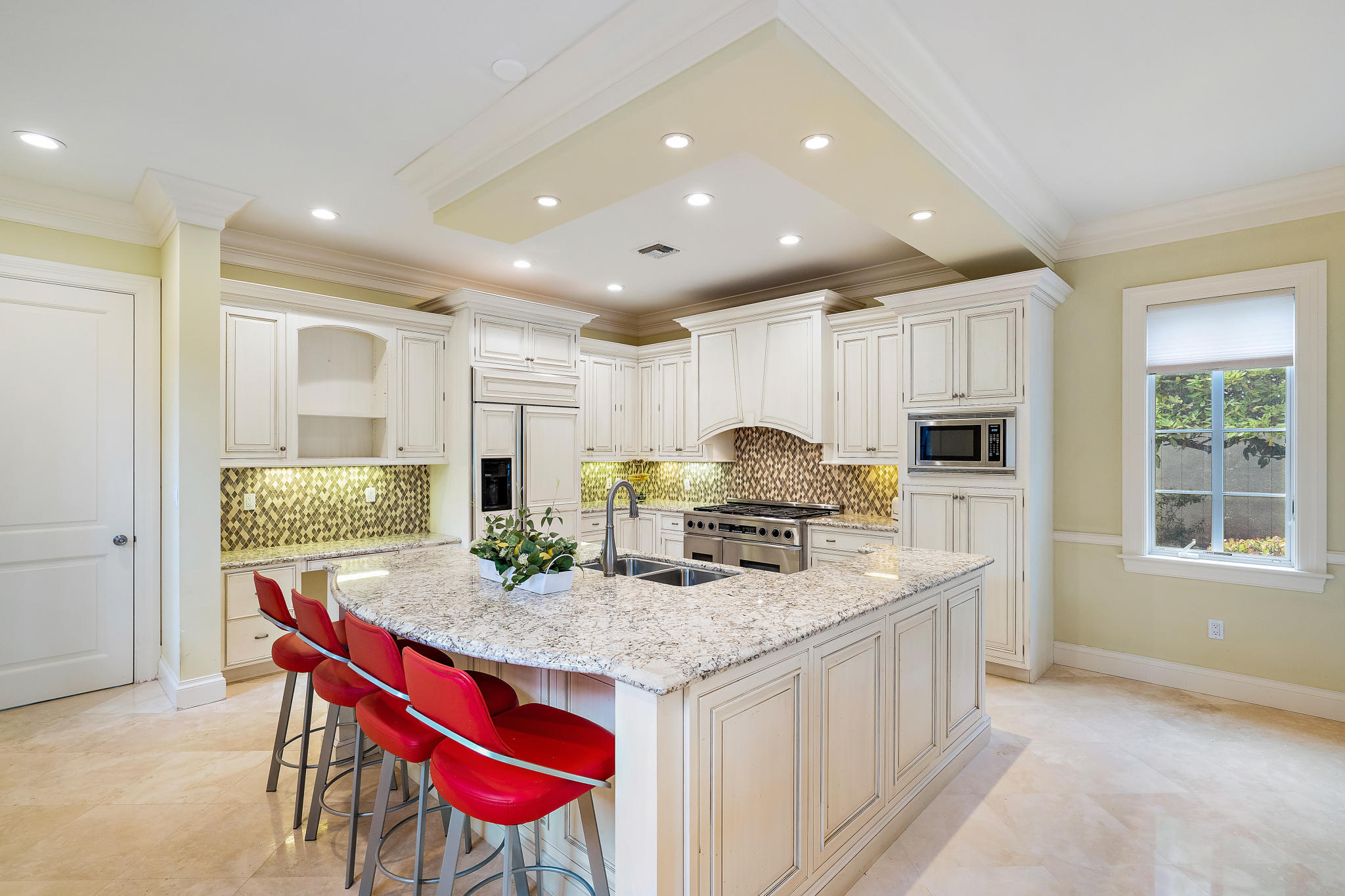 426 Red Hawk Drive Jupiter, FL 33477 - Photo 6 of 40 a kitchen with stainless steel appliances granite countertop a kitchen island hardwood floor sink stove and granite counter top