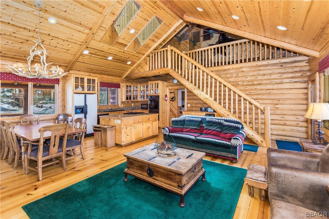 43574 Shasta Road Big Bear Lake, CA 92315 - Photo 4 of 37 a living room with furniture gym equipment and a rug