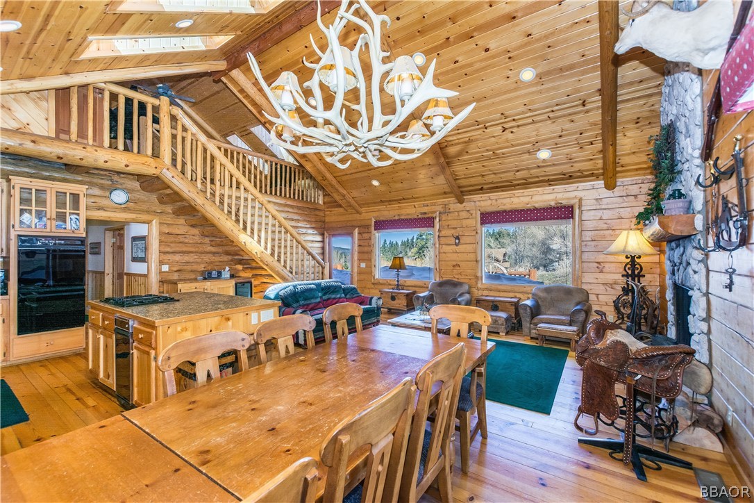 43574 Shasta Road Big Bear Lake, CA 92315 - Photo 6 of 37 a living room with lots of furniture and a chandelier