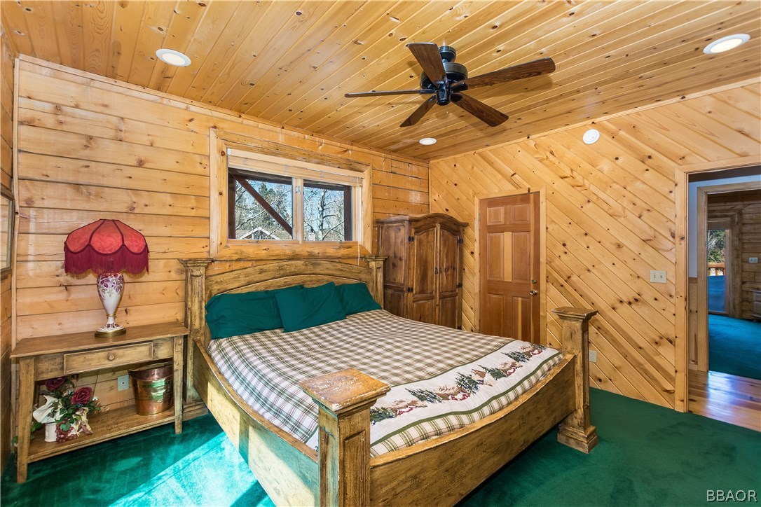 43574 Shasta Road Big Bear Lake, CA 92315 - Photo 10 of 37 a bedroom with a bed a dresser next to a window