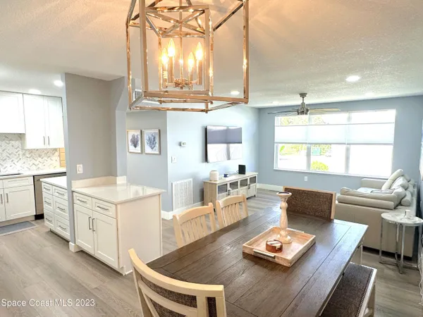 a living room with furniture and view of kitchen