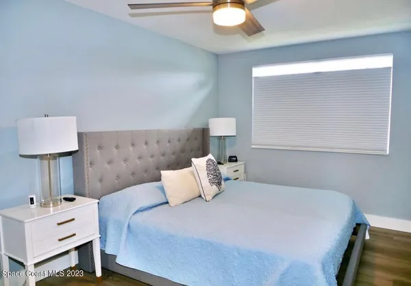 a bedroom with a bed and a lamp