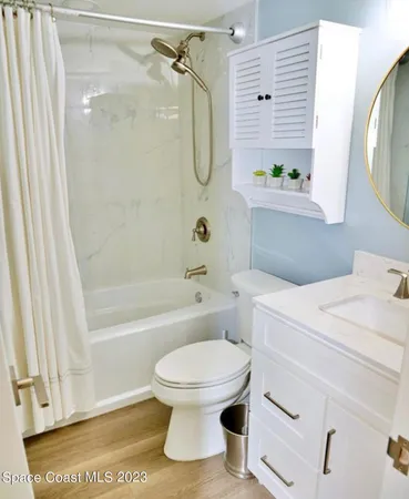 a bathroom with a granite countertop toilet sink and shower