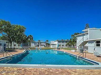 a view of a swimming pool with an outdoor seating