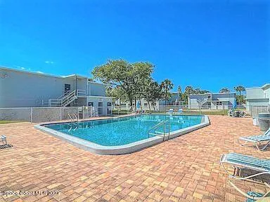 a view of a swimming pool with an outdoor space and seating area