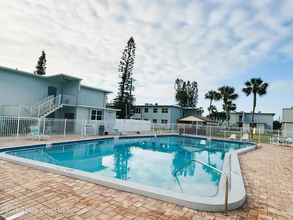 a view of a swimming pool with outdoor seating