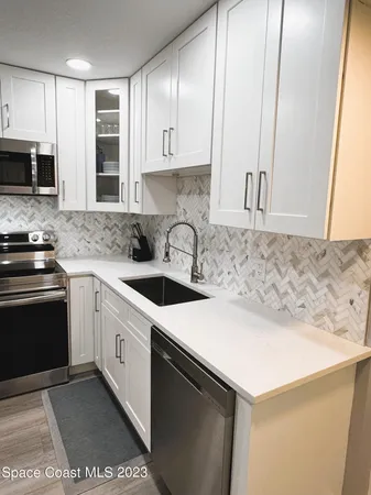 a kitchen with a sink cabinets and appliances