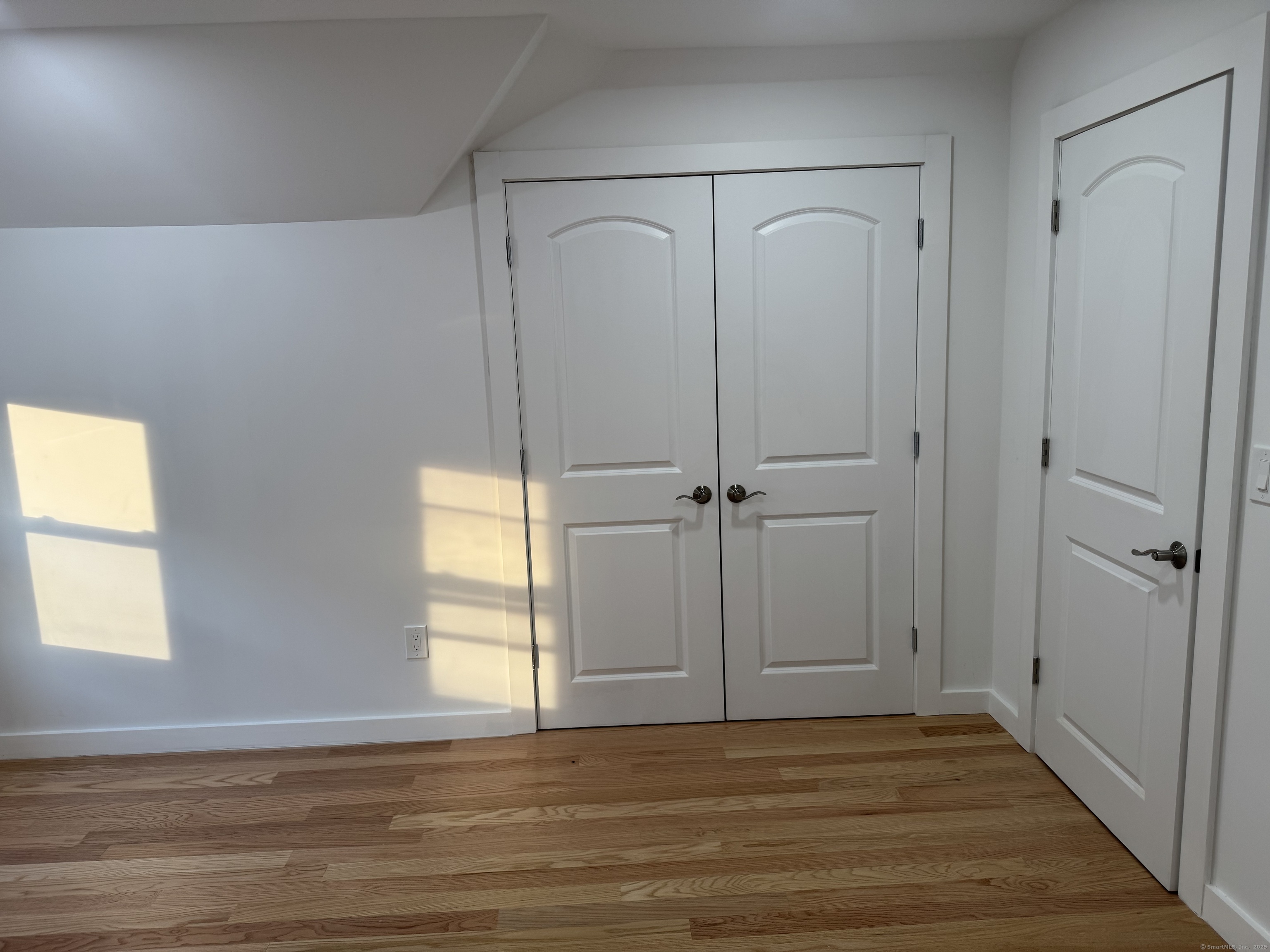 263 Hawley Avenue Bridgeport, CT 06606 - Photo 11 of 19 a view of an empty room with wooden floor and a window